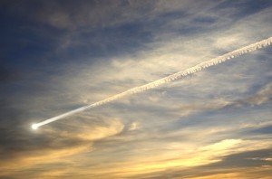 Photo of meteor streaking across evening sky, wispy clouds